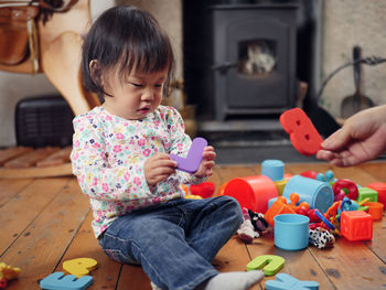 Baby girl playing with toys at home