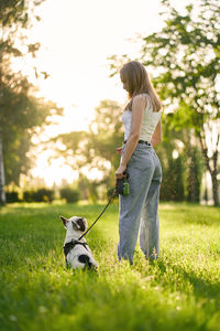 Woman with dog on field