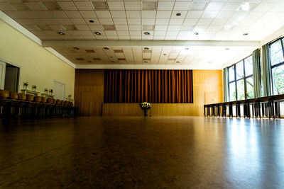 View of chairs next to table in hall