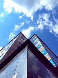 Low angle view of modern building against cloudy sky