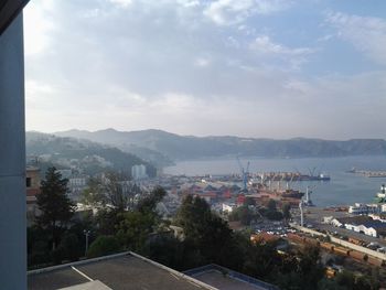 High angle view of buildings by sea against sky