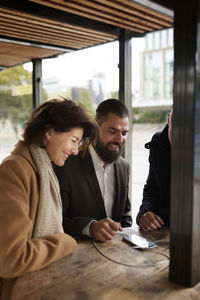 Smiling business people talking together