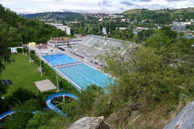 High angle view of swimming pool by buildings in city