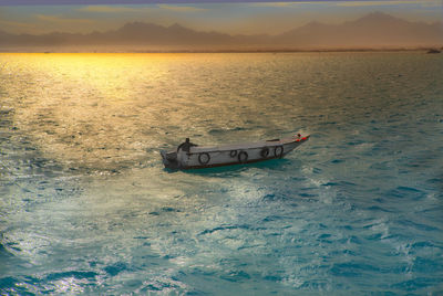 View of boat on sea against sky during sunset