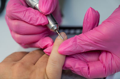 Close-up of hand holding syringe