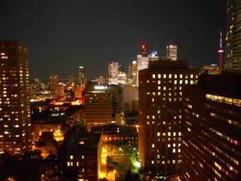 Illuminated cityscape against sky at night