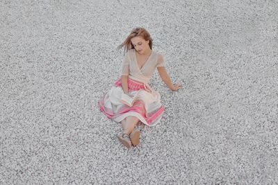 High angle portrait of young woman on beach