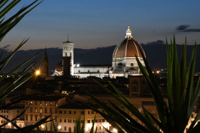 Low angle view of illuminated buildings against sky at night