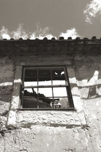 Low angle view of built structure against cloudy sky