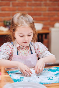 Close-up of girl looking at table