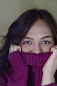 Close-up portrait of woman covering face