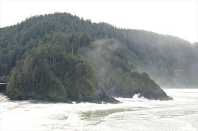 Scenic view of waterfall against sky