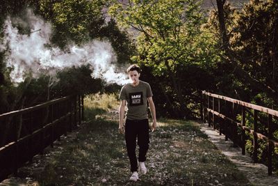 Full length of man standing on footbridge
