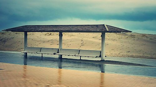 Lifeguard hut on beach against sky