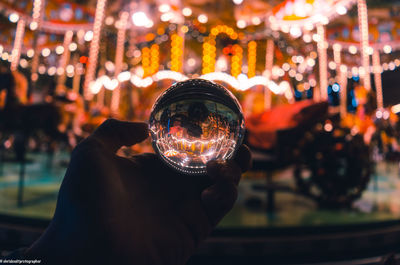 Close-up of hand holding crystal ball