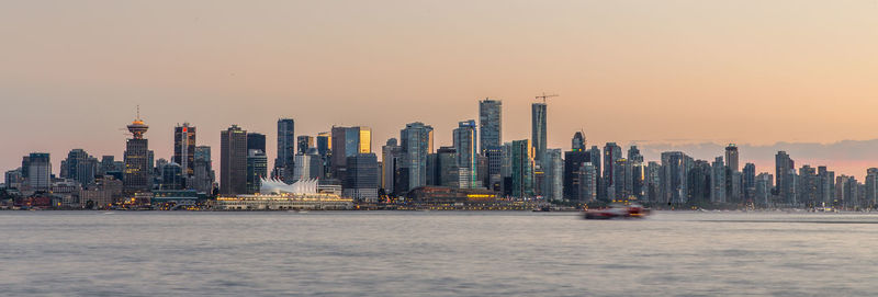 Modern buildings in city at sunset