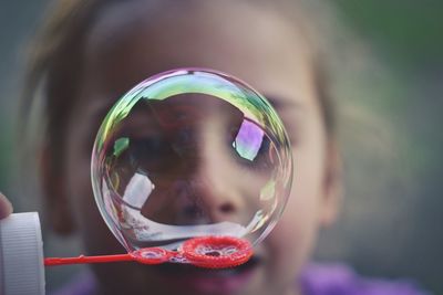 Close-up of girl blowing bubble