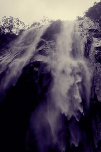 Close-up of waterfall against sky