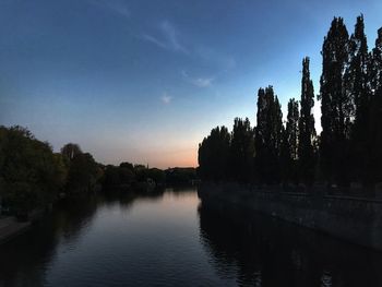 Scenic view of lake against sky at sunset