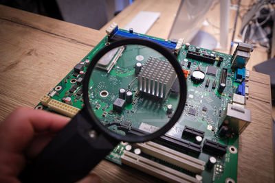 Cropped hand of man using mobile phone