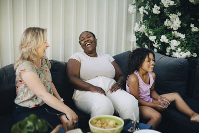 Cheerful mothers laughing during party at backyard