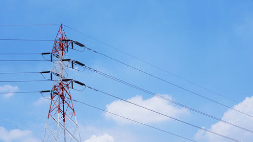 Low angle view of electricity pylon against sky