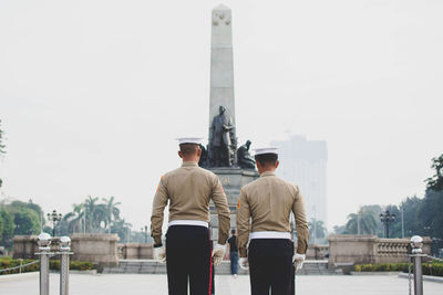 Rear view of two people against the sky