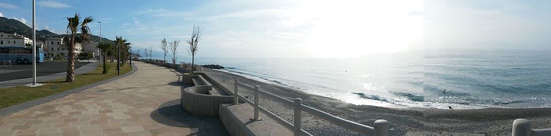 Panoramic view of city by sea against sky