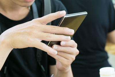 Midsection of woman using mobile phone