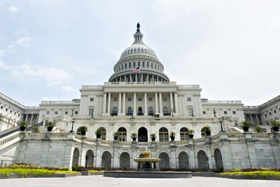 Low angle view of government building against cloudy sky