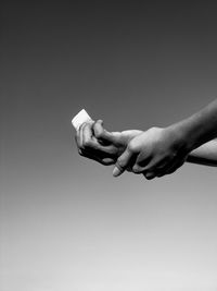 Close-up of hands over white background