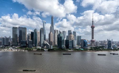 View of buildings in city against cloudy sky