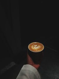 Person holding coffee cup