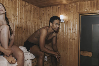 Couple sitting in sauna