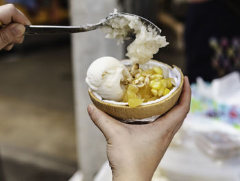 Close-up of hand holding ice cream