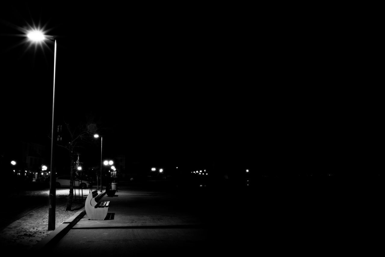 ILLUMINATED STREET LIGHTS AT NIGHT