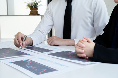 Midsection of man working at table