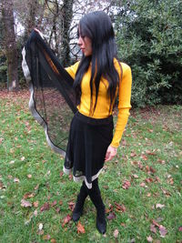 Woman standing by plants