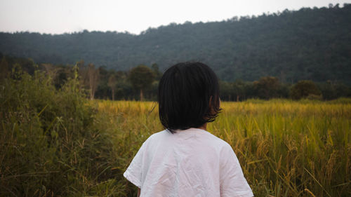 Rear view of man standing on field