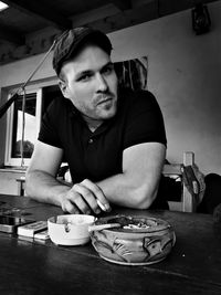 Portrait mid adult man sitting on restaurant table