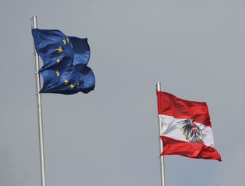 Low angle view of flag against blue sky