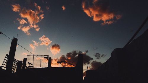 Low angle view of built structure against sky at sunset