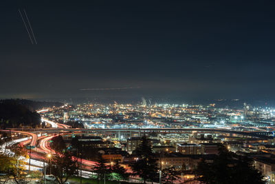 High angle view of illuminated buildings in city at night