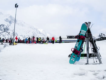 People in ski lift against sky during winter