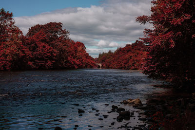 Scenic view of waterfall against sky during autumn