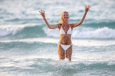 Rear view of woman standing in water