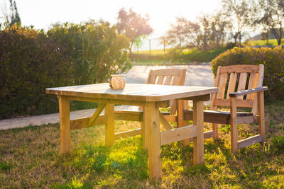 Wooden chairs and table on field