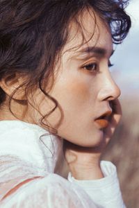 Close-up portrait of young woman looking away