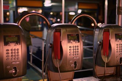 Close-up of pay phones in city at night