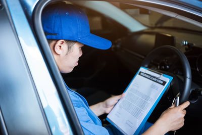 Man using mobile phone in car